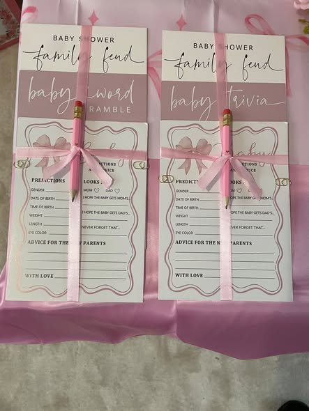 Baby shower family feud game cards tied with pink ribbon