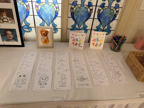 Coloring page activity table with crayons at a baby shower