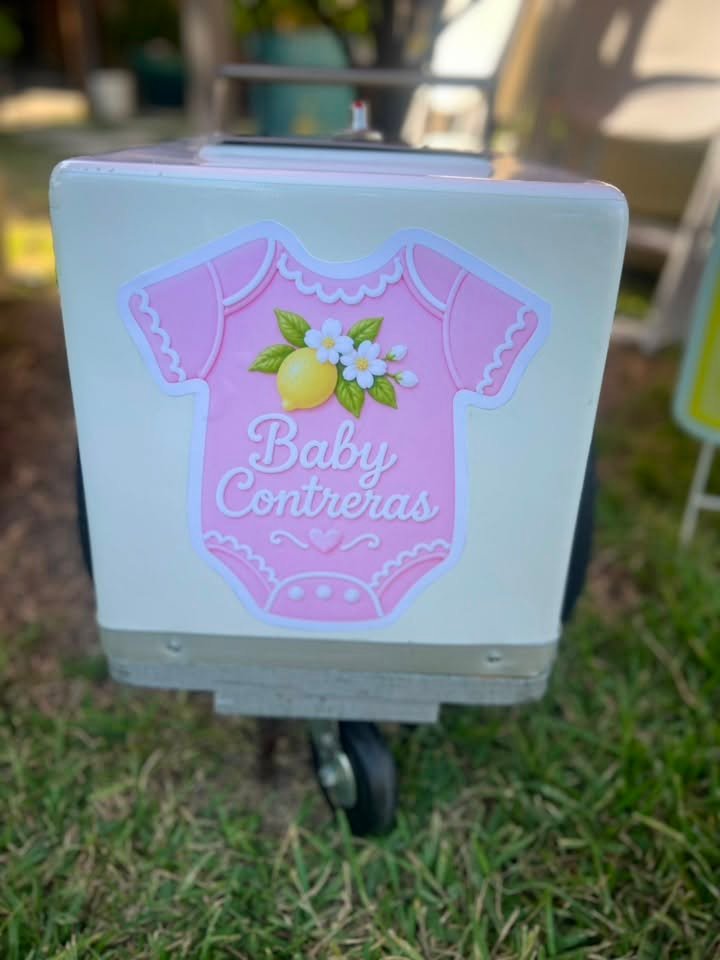 Pink baby onesie sign with lemons on a cooler cart