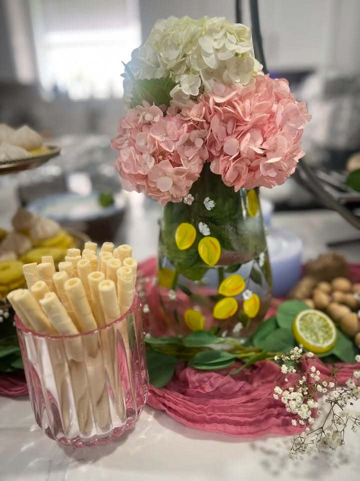 Pink hydrangea and lemon centerpiece in a glass vase