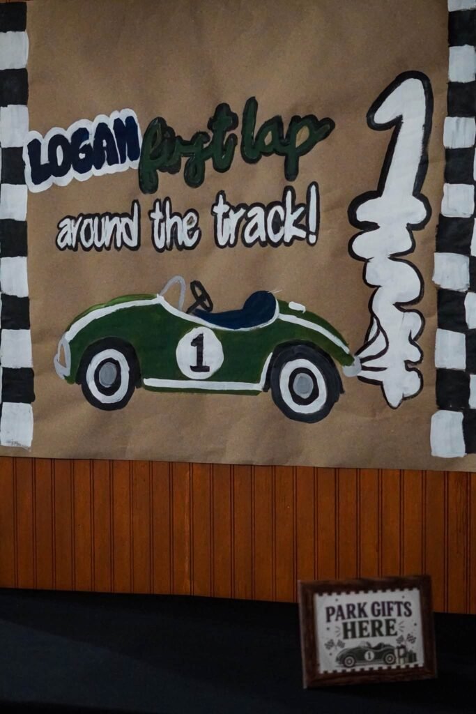Kraft paper First Lap Around the Track banner with a race car and number 1