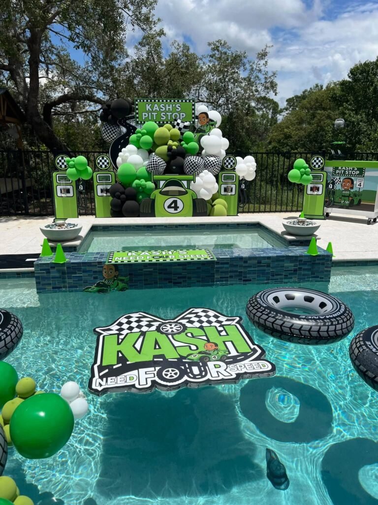 Race car pool party with floating tire tubes and a race logo float