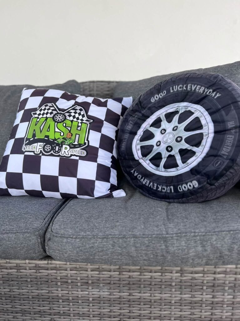 Checkered and tire print pillows on an outdoor sofa