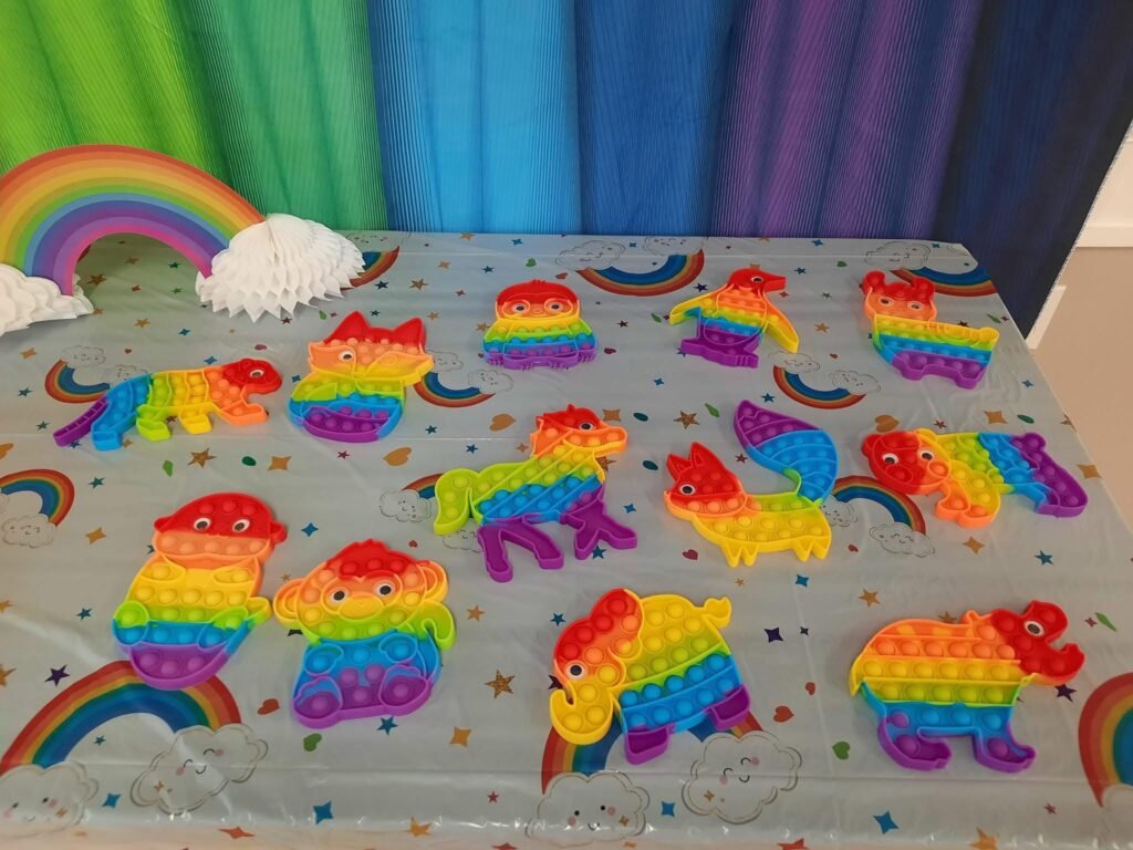 Rainbow pop it toys laid out as favors