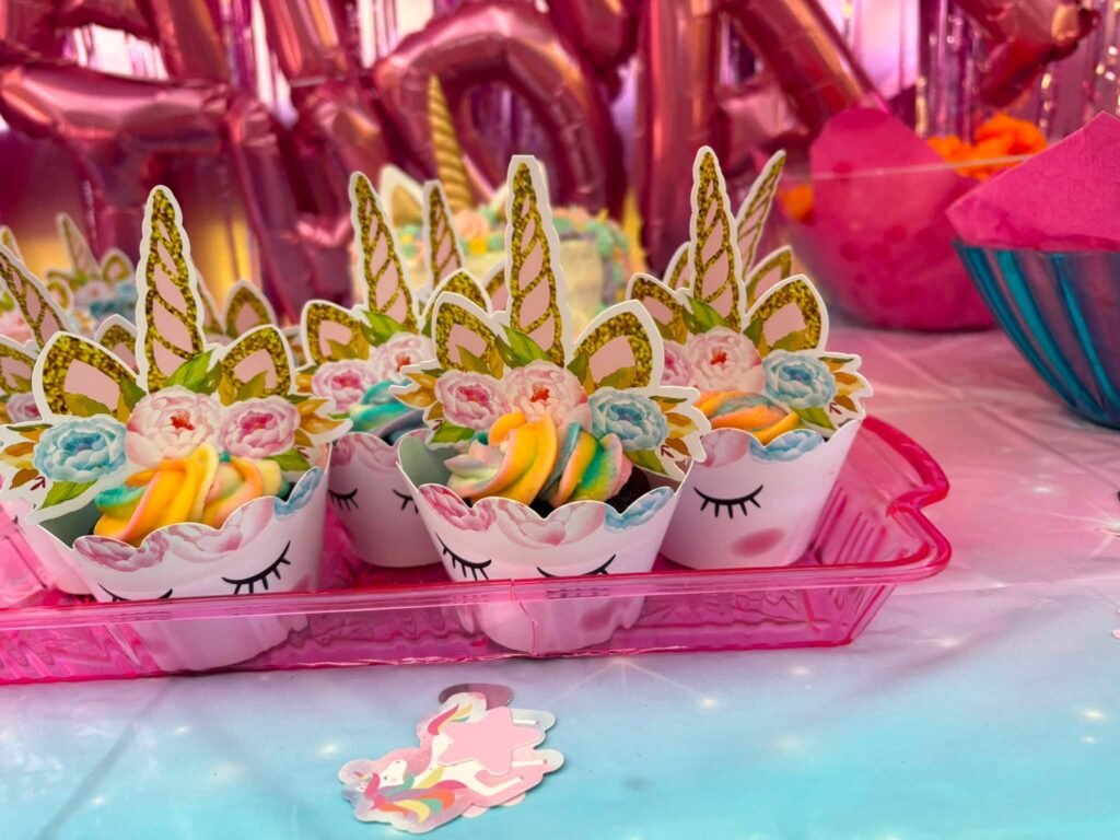 Unicorn face cupcakes on a pink tray