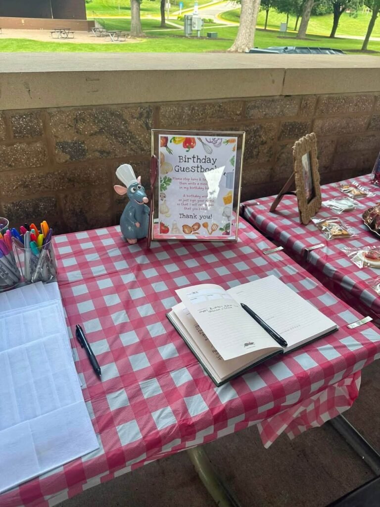 Table with a framed sign, pens and a recipe book