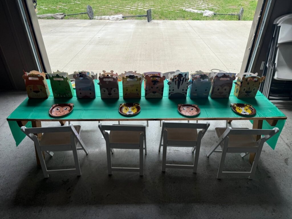 Green tree favor cups lined up on a long table