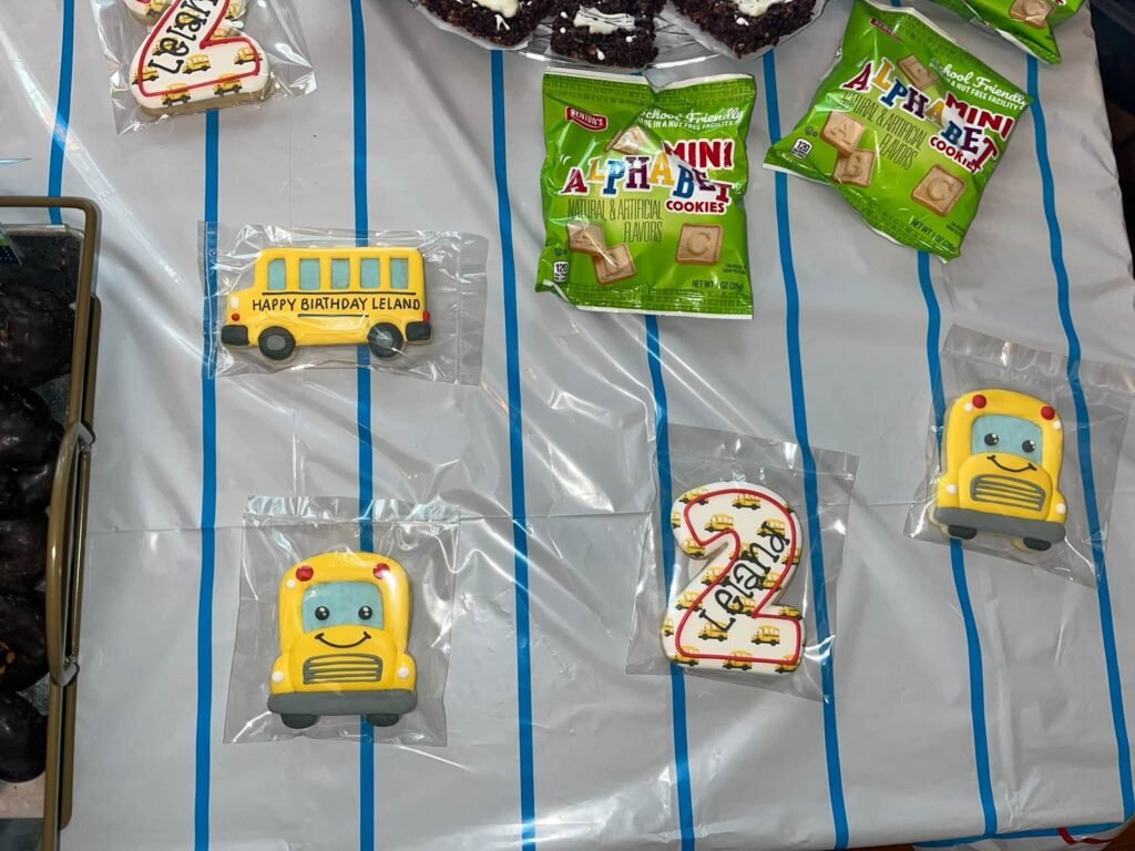 School bus cookies and snacks on a blue striped table