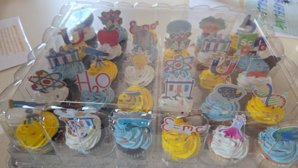 Cupcakes with science toppers in a tray