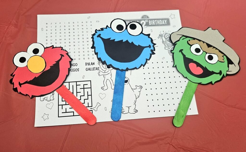 Sesame Street activity sheet with Elmo, Cookie Monster and Oscar paddle props