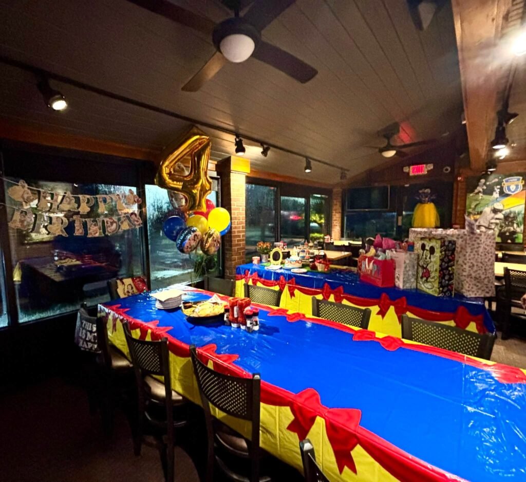 Long blue party table with yellow and red details