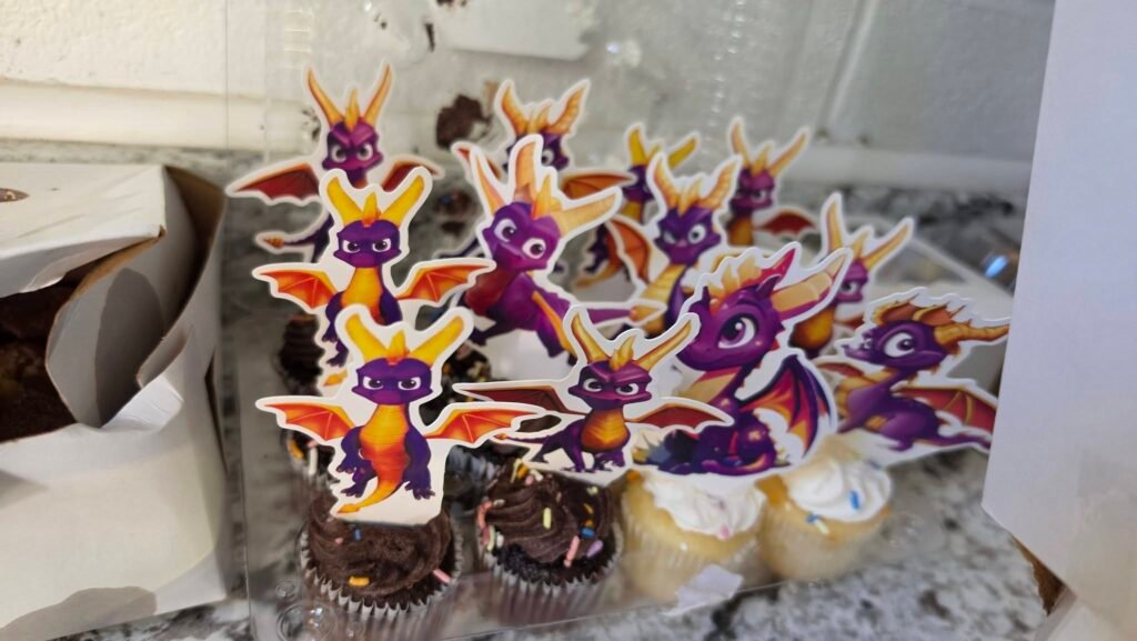 Chocolate cupcakes with Spyro dragon toppers on a counter