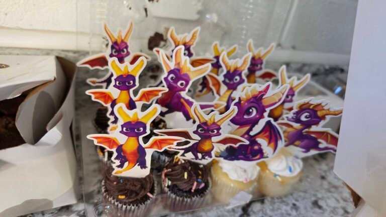 Chocolate cupcakes with Spyro dragon toppers on a counter