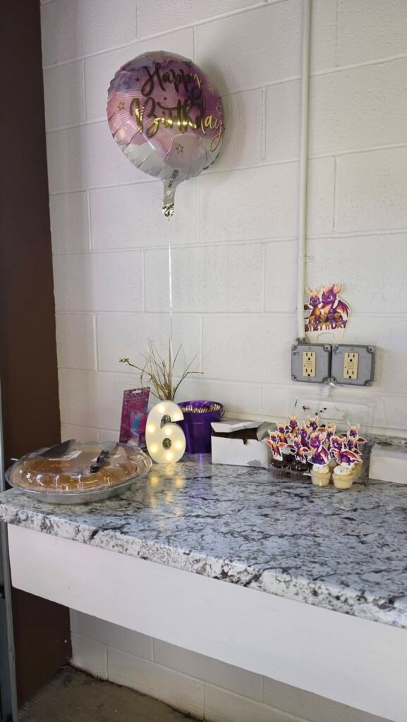 Party counter with a purple balloon and favors
