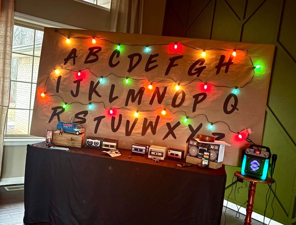 Wall with painted alphabet letters and colored Christmas lights