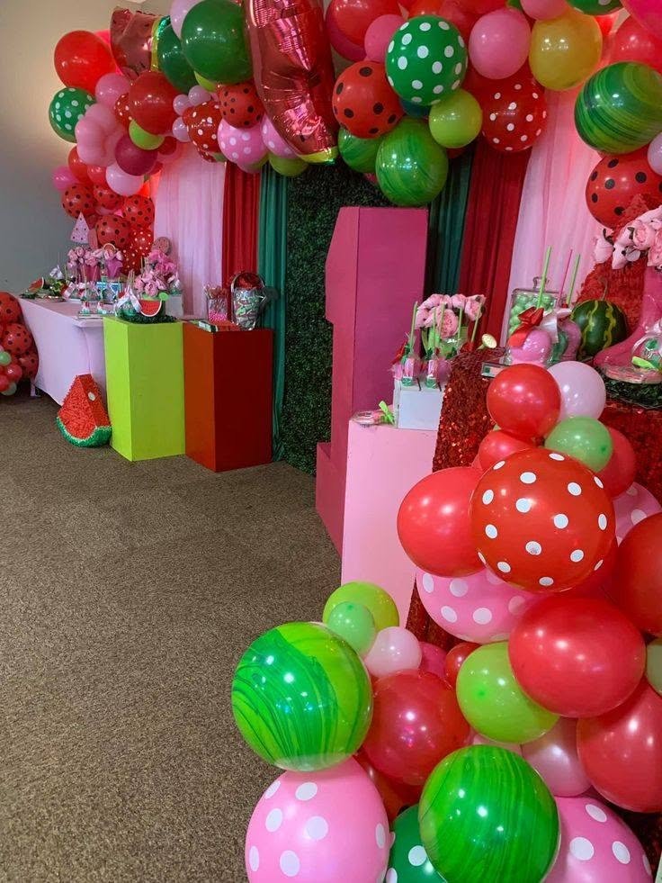 Red polka dot balloons that look like strawberries in a balloon garland