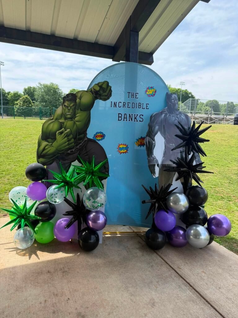 Hulk superhero welcome sign with black, purple and green balloons