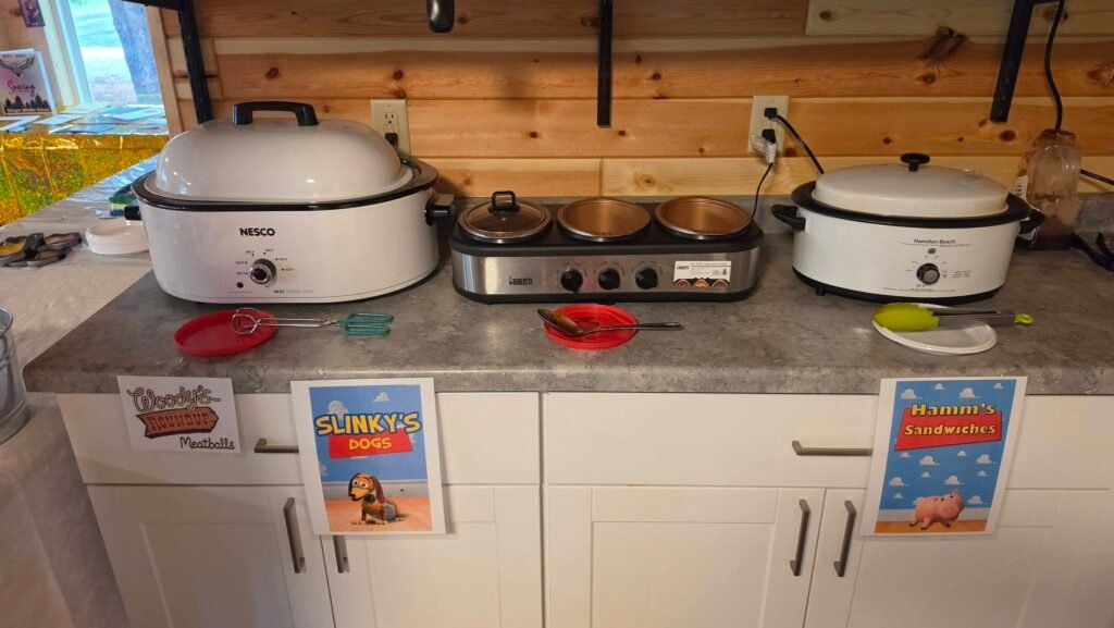 Crockpots with Toy Story food labels on a kitchen counter