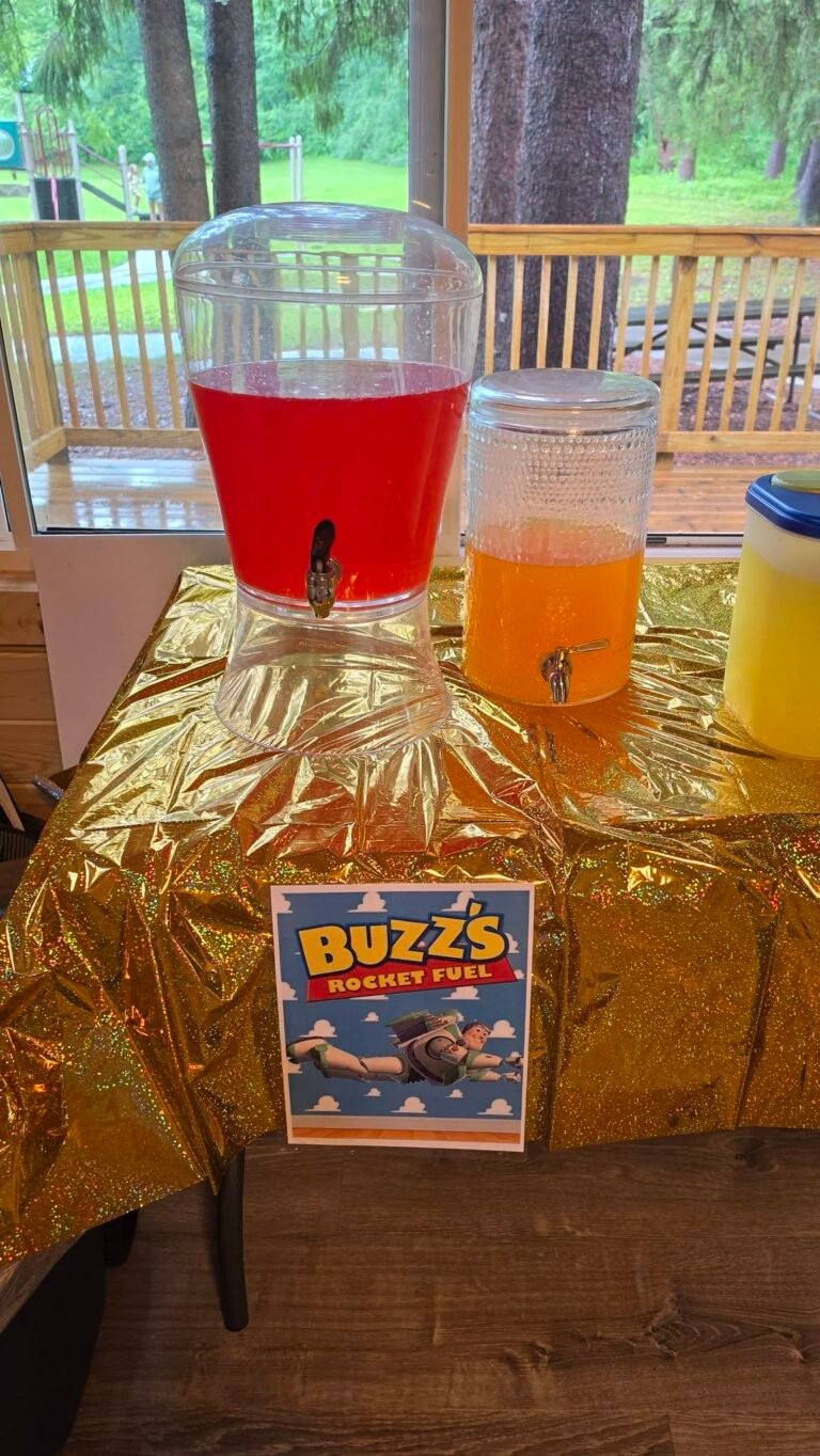 Buzz drink station with punch and lemonade dispensers on a gold table