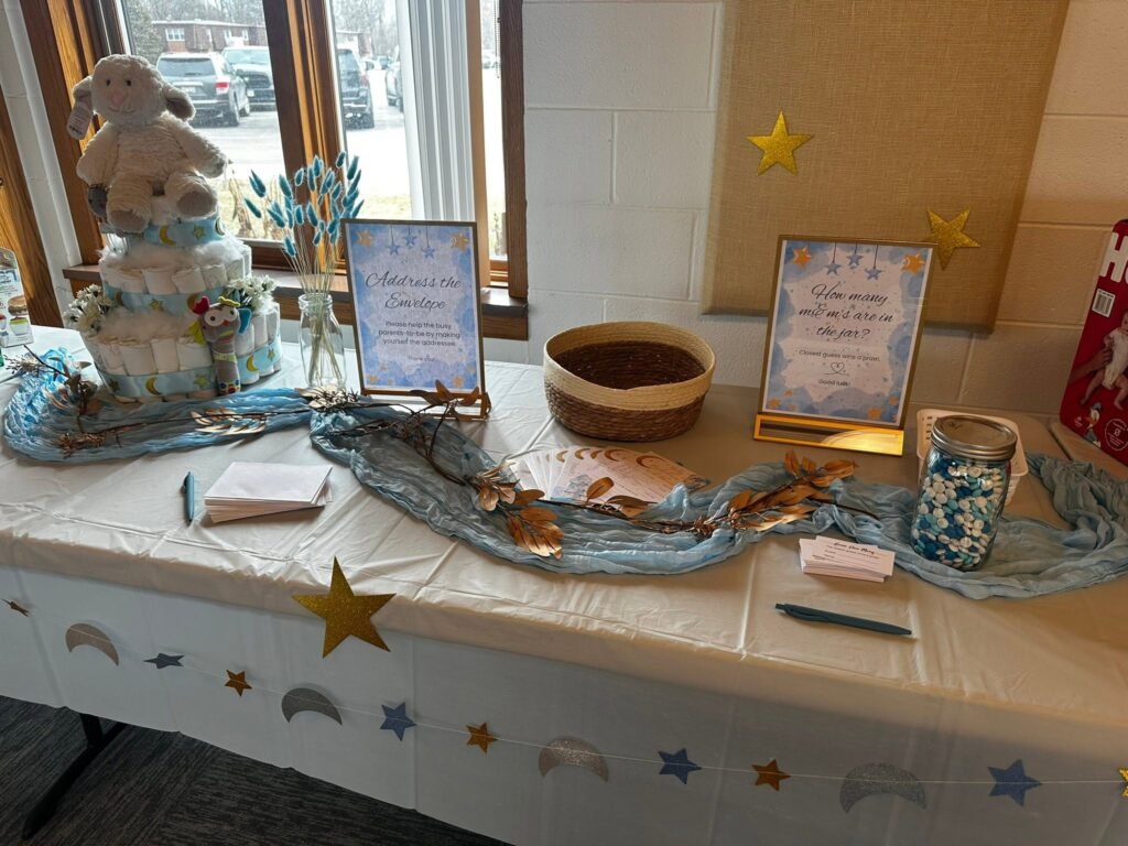 Gift and guest book table with blue tulle and gold star cutouts on the cloth