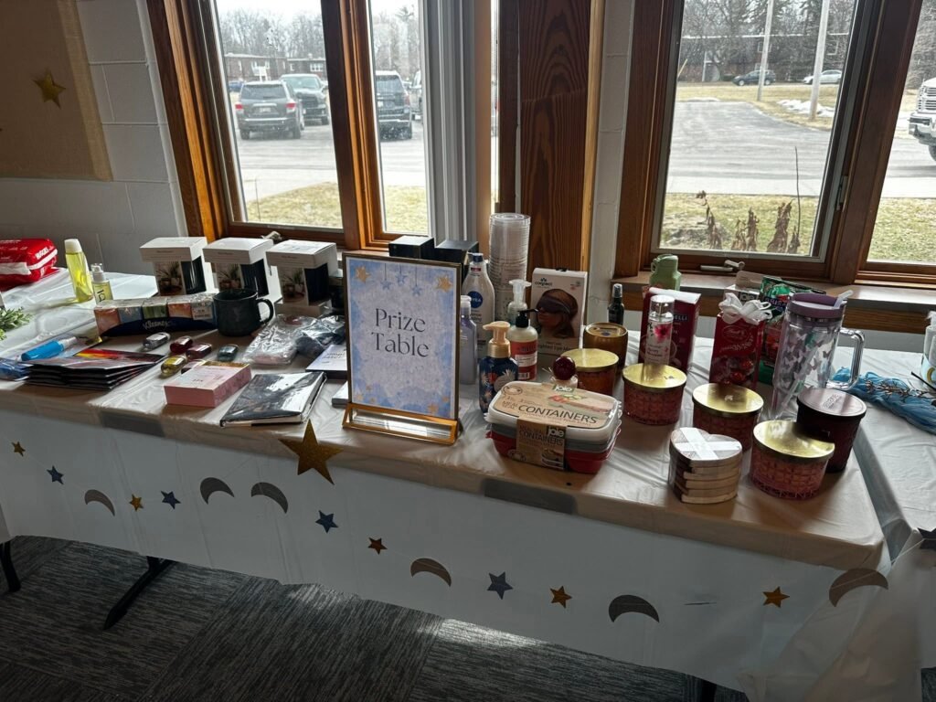 Favor table with treats, a sign and star decor by the window