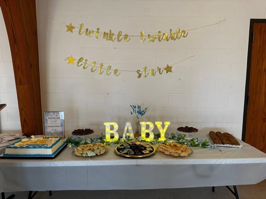 Baby shower food table with BABY marquee letters and a Twinkle Twinkle Little Star banner