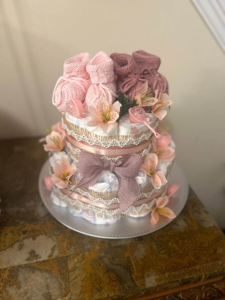 Pink diaper cake with flowers and bows
