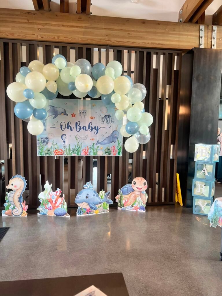 Oh Baby balloon arch in pastel blue and white with sea animal cutouts