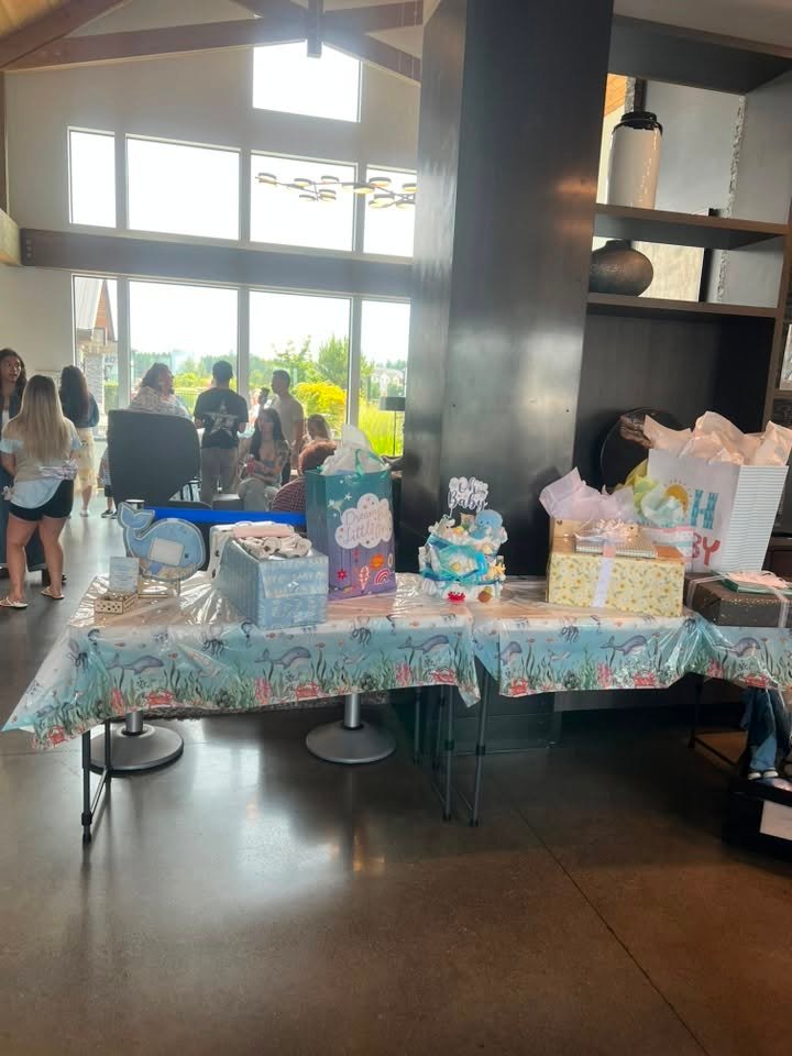 Baby shower gift table with blue cloth and wrapped gifts