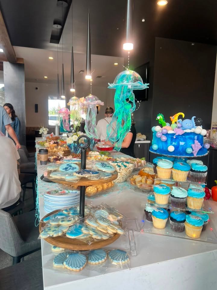 Blue cupcakes and sea cookies under jellyfish lanterns