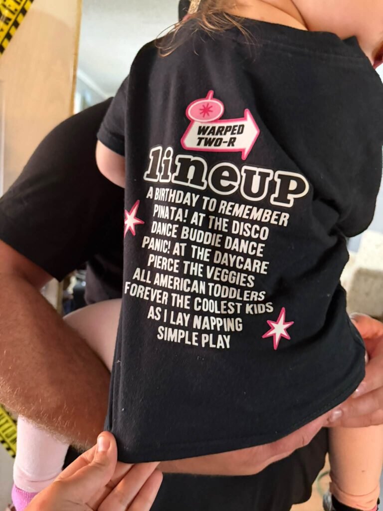 Back of a black shirt with a tour lineup list