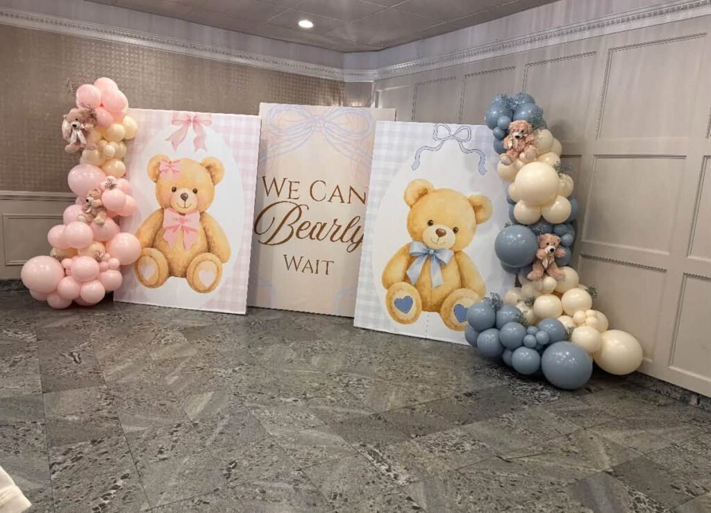 Pink and blue balloon garland around teddy bear panels