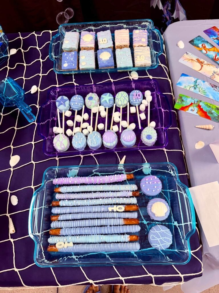 Dragon treats with pretzel rods and dipped bites on a net