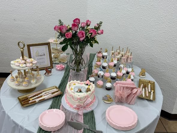 Winnie the Pooh baby shower dessert table with pink roses, cupcakes and treats