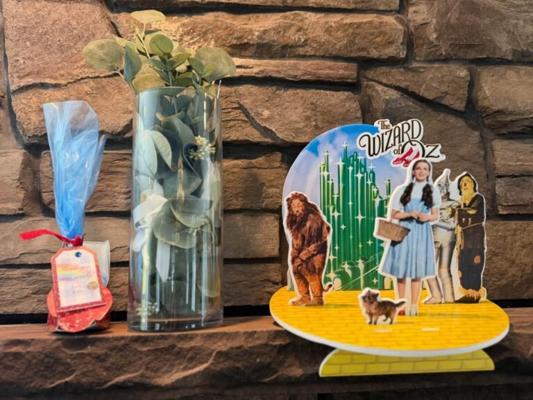 Table decor with an Oz scene cutout and a green vase