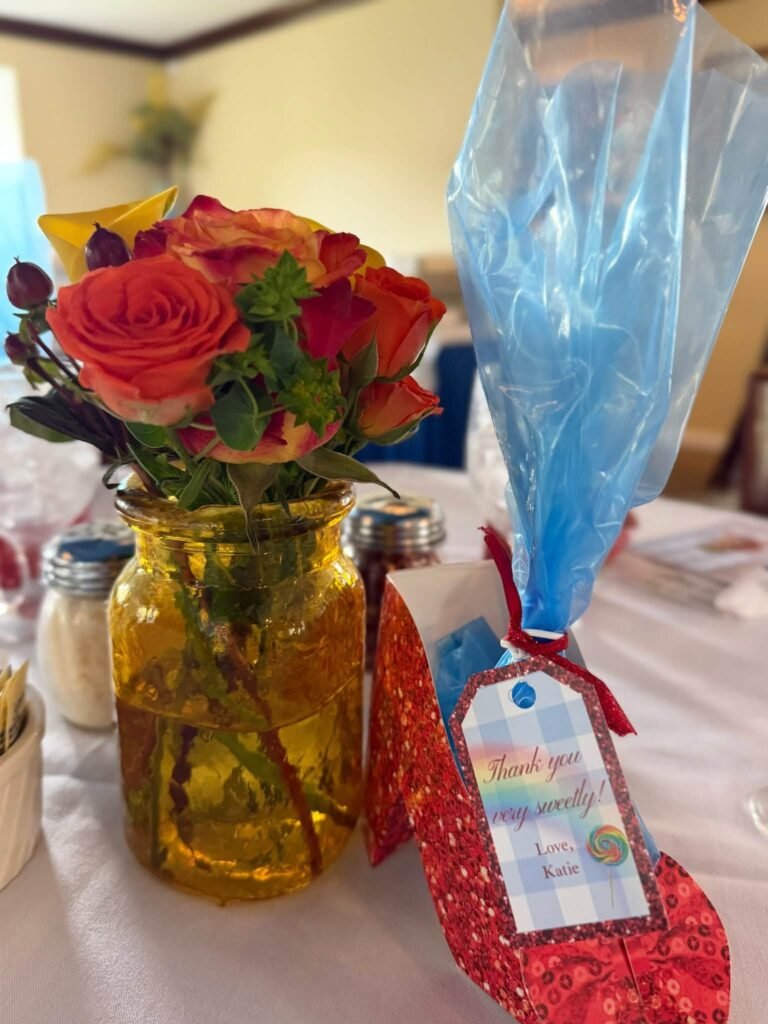 Mason jar flowers with a glitter ruby slipper favor bag