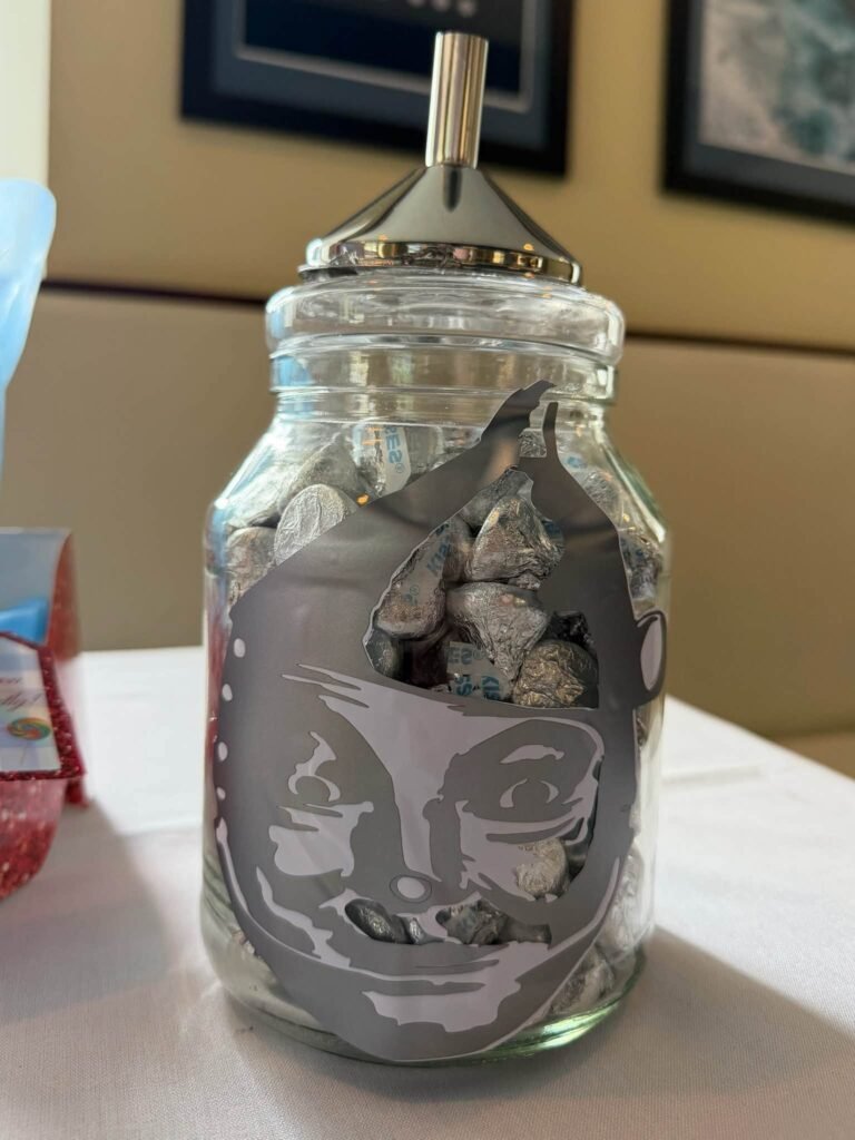 Glass jar with a printed face wrap and funnel top