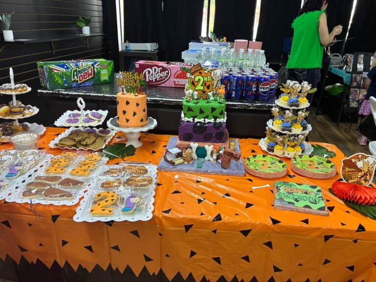 Orange table with stone age snacks, sodas and treats